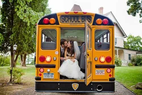 Beautiful school bus for wedding couple kissing