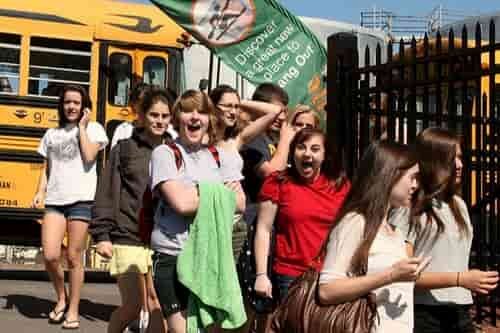 happy students on rented coach school bus
